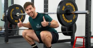 Image of PT Matt doing a barbell squat while giving the thumbs up